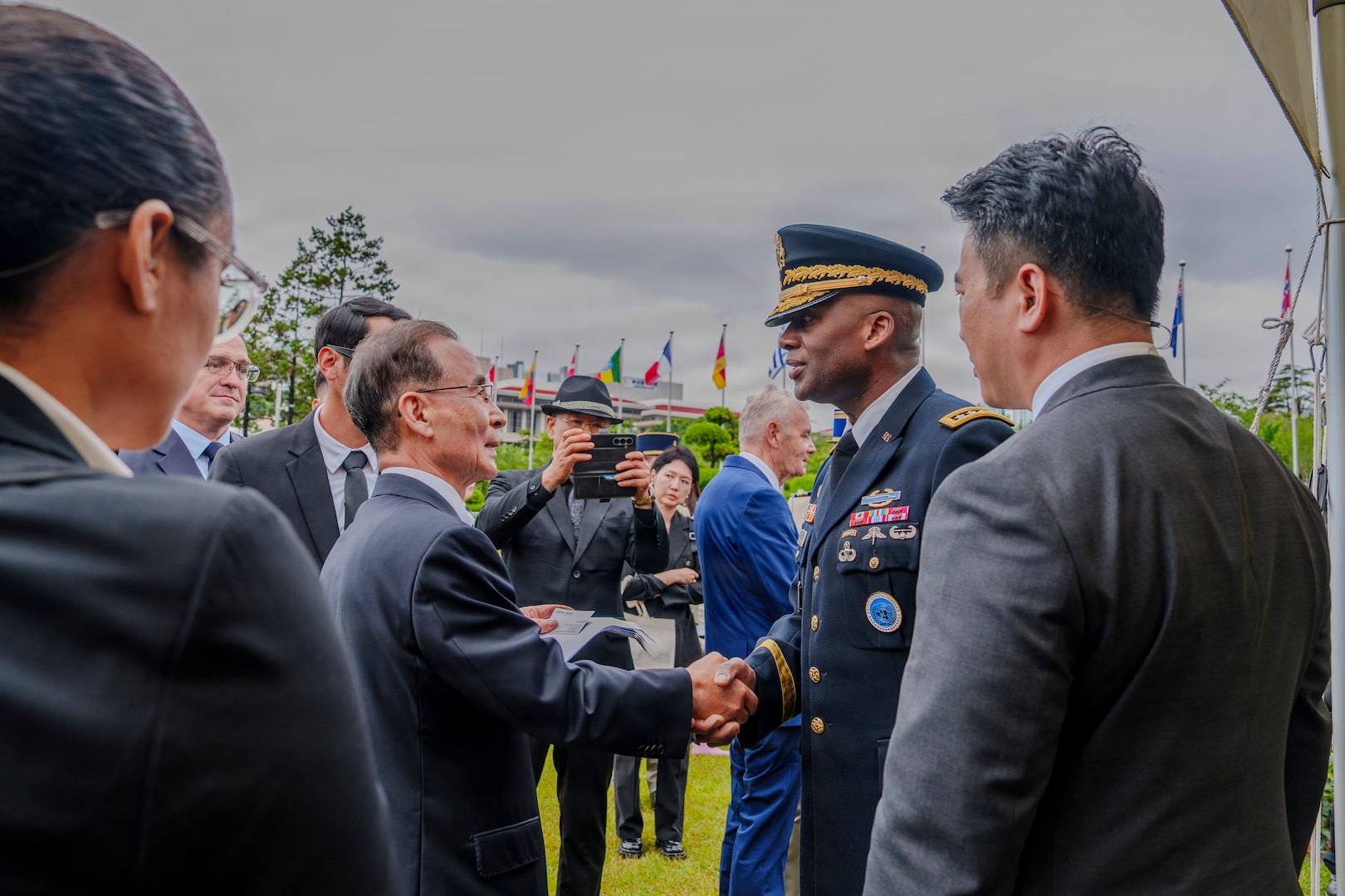 U.S. Army Gen. Xavier T. Brunson, commander of United Nations Command, Combined Forces Command, and U.S. Forces Korea, greets Sun Jeong‑in, custodian of the United Nations Memorial Cemetery Korea, after an interment ceremony for former French Korean War veterans André Datcharry and Jacques Grisolet in Busan, South Korea, on May 27, 2026.