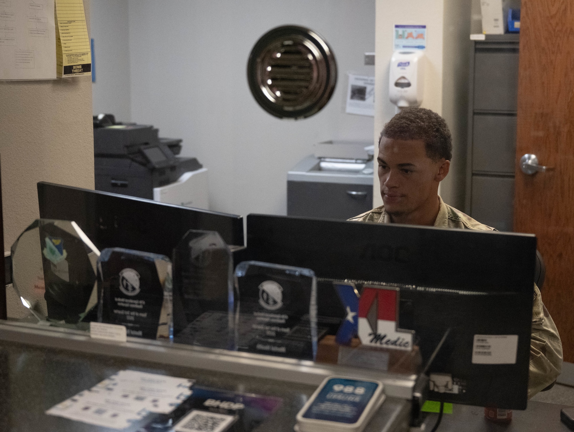 U.S. Air Force Airman 1st Class Charles Curtis, Laughlin Operational Medical Readiness Squadron (LOMRS) mental health technician, sits in mental health flight front desk at Laughlin Air Force Base, Texas, June 1, 2026. The LOMRS mental health flight aids Airmen and civilians in effectively coping with their mental stressors. (U.S. Air Force photo by Airman 1st Class Darryl Keith)