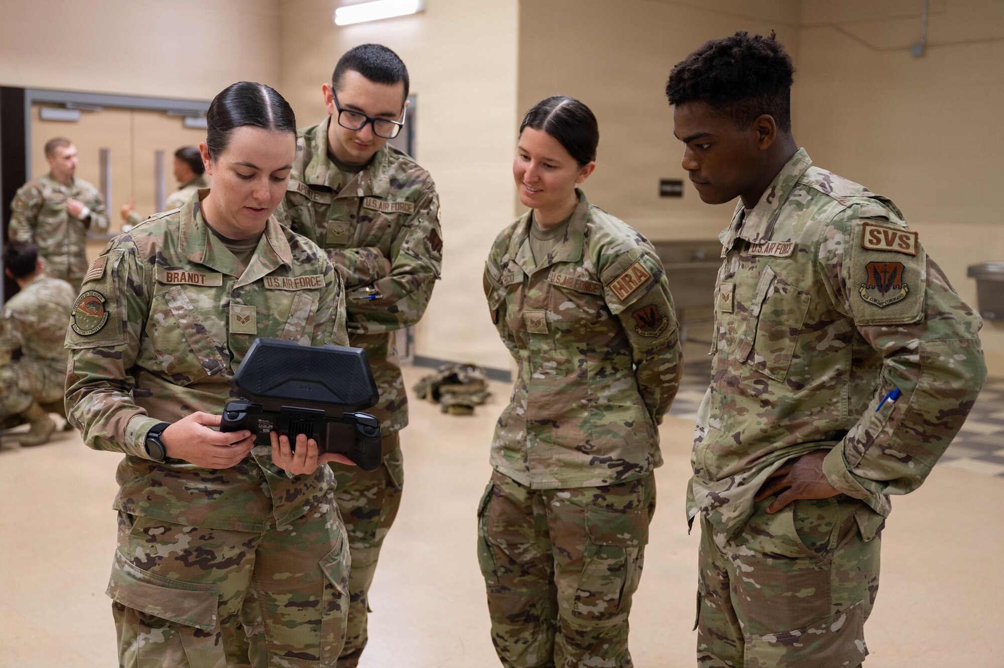 Airmen fly a drone.