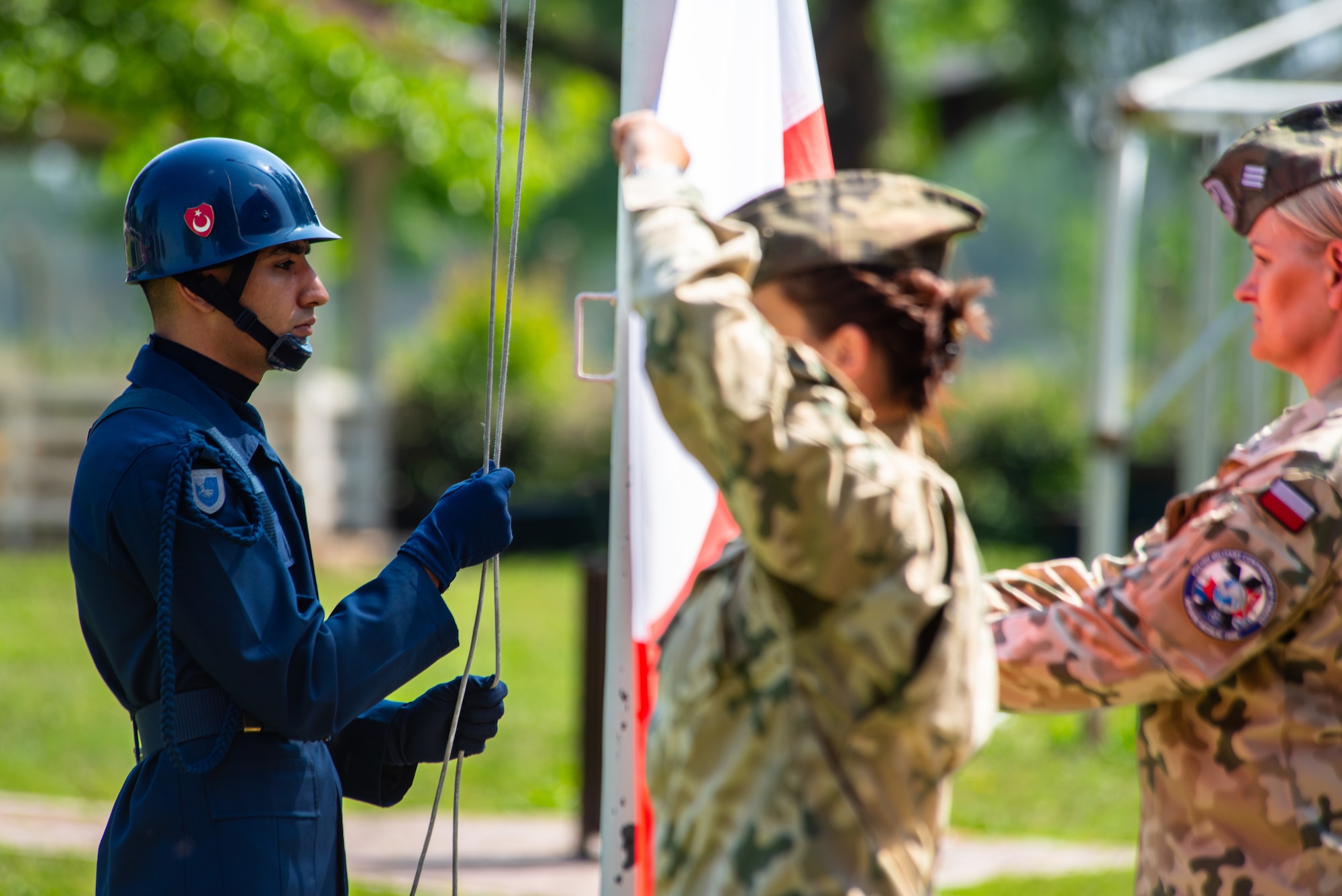A Turkish air force member raises the Turkish flag