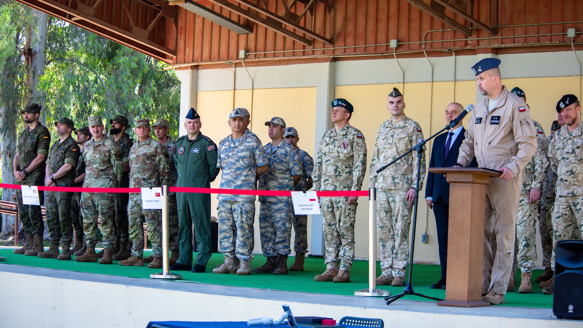 A Polish military member delivers remarks