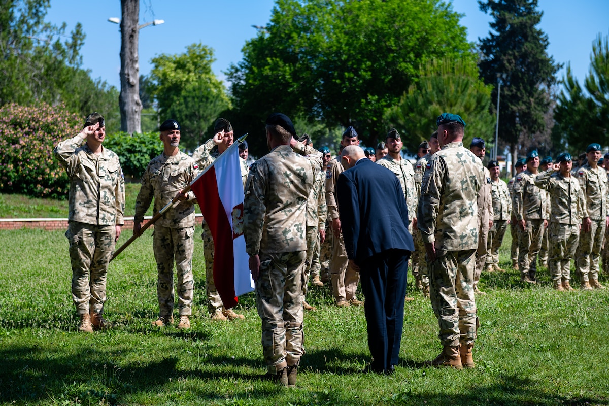 Polish Military Contingent members render salutes