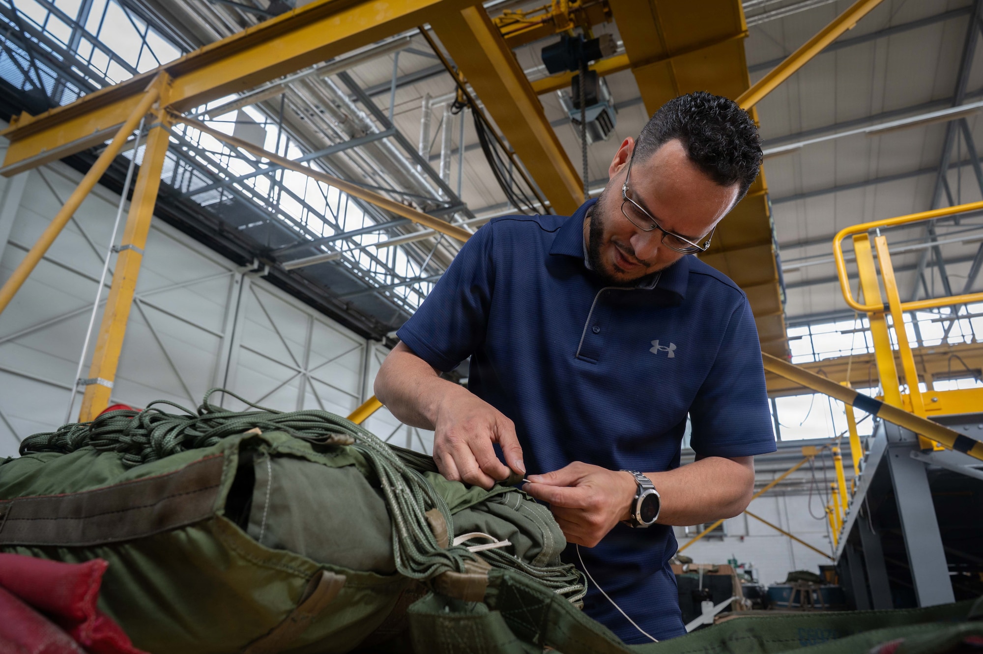 Charlie Garcia, 86th Logistics Readiness Squadron aerial delivery supervisor, secures a parachute at Ramstein Air Base, Germany, May 21, 2026.