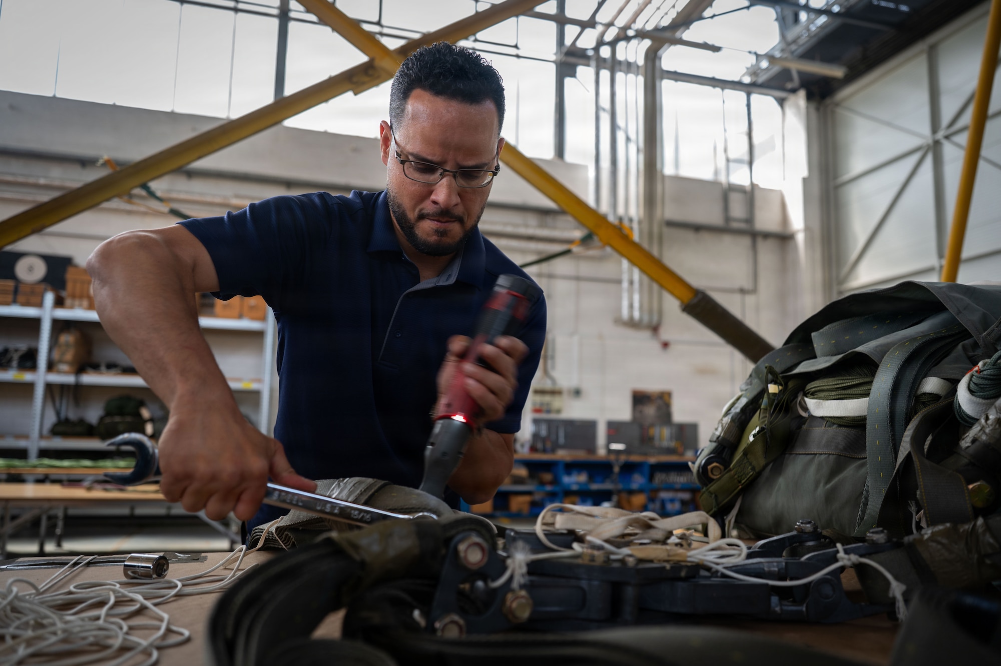Charlie Garcia, 86th Logistics Readiness Squadron aerial delivery supervisor, performs maintenance on a parachute assembly at Ramstein Air Base, Germany, May 21, 2026.