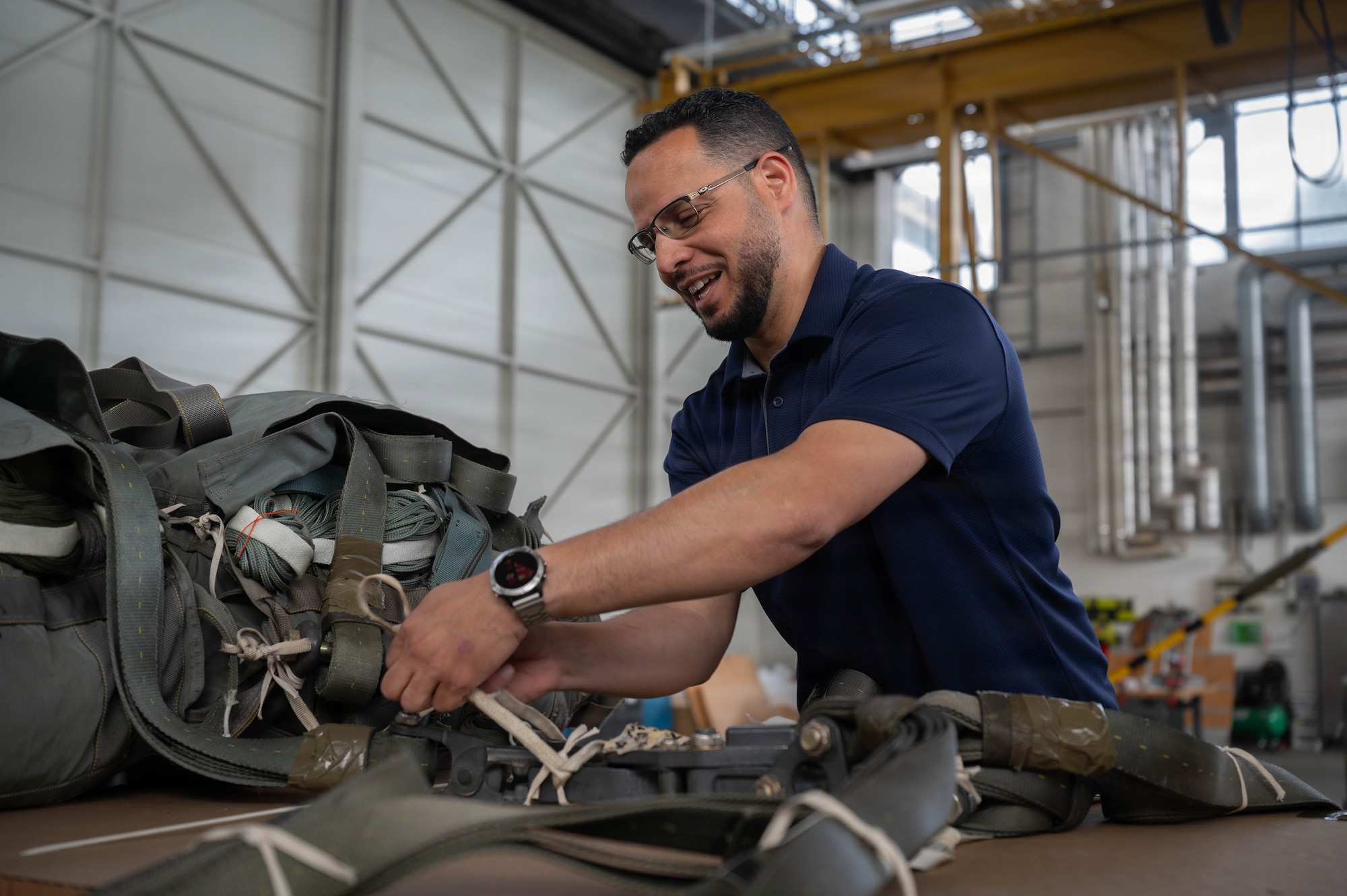 Charlie Garcia, 86th Logistics Readiness Squadron aerial delivery supervisor, prepares parachute inspection lines at Ramstein Air Base, Germany, May 21, 2026.