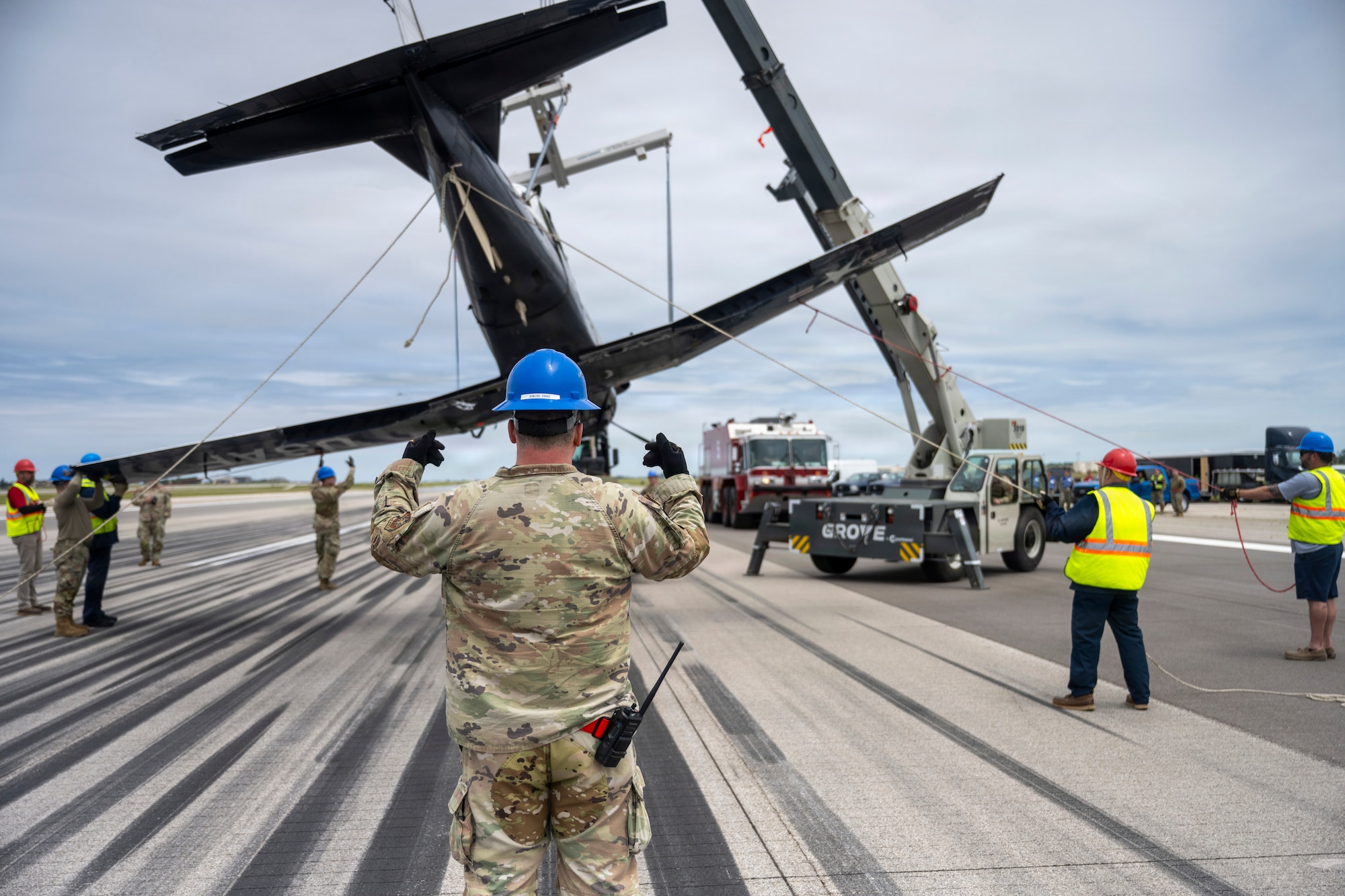 Members of Vance Air Force Base, Oklahoma's Crash Damaged Disabled Aircraft Recovery team remove a T-6A Texan II from McConnell Air Force Base, Kansas's flightline May 20,2026. The T-6A, from Vance AFB, performed an emergency belly-landing due to a landing gear malfunction, avoiding injury to both aircrew members. (U.S. Air Force photo by Airman 1st Class Tavian Sims)