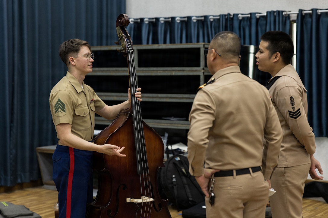 U.S. Marine Corps Sgt. Cole Yates, a bass instrumentalist with the III Marine Expeditionary Force Band, educates members of the Royal Thai Navy during a visit at the Bangkok Naval Base, Bangkok, Royal Kingdom of Thailand, Jan. 26, 2026. The performance aims to strengthen military-to-military ties within the U.S.-Thailand alliance and foster cultural exchange through the universal language of music. Yates is a native of Texas. (U.S. Marine Corps photo by Lance Cpl. Justin Cledera)