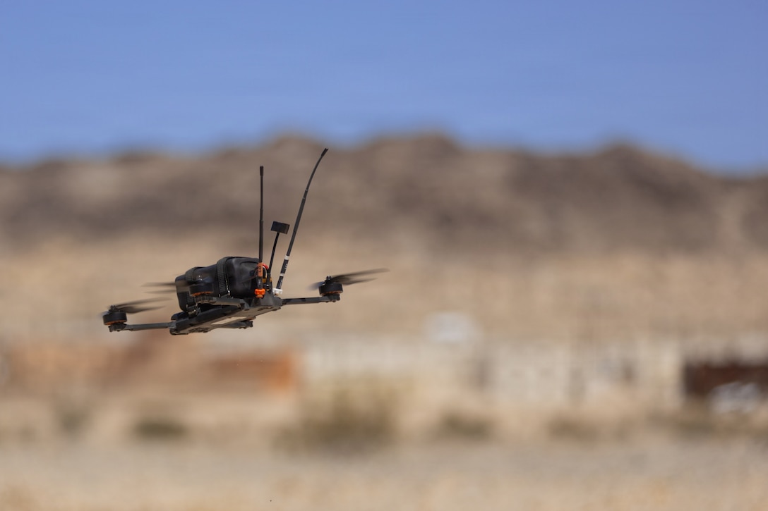 An Archer drone hovers above the ground during the Attack Drone Operator Course at Range 100, Marine Corps Air Ground Combat Center, Twentynine Palms, California, May 21, 2026. Through intensive hands-on training, the course equips service members with tactical first-person view piloting skills, directly enhancing lethality and survivability in contested environments. (U.S. Marine Corps photo by Pfc. Ethan DePaul)