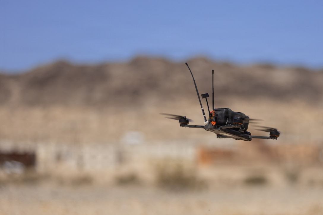 An Archer drone hovers above the ground during the Attack Drone Operator Course at Range 100, Marine Corps Air Ground Combat Center, Twentynine Palms, California, May 21, 2026. Through intensive hands-on training, the course equips service members with tactical first-person view piloting skills, directly enhancing lethality and survivability in contested environments. (U.S. Marine Corps photo by Pfc. Ethan DePaul)