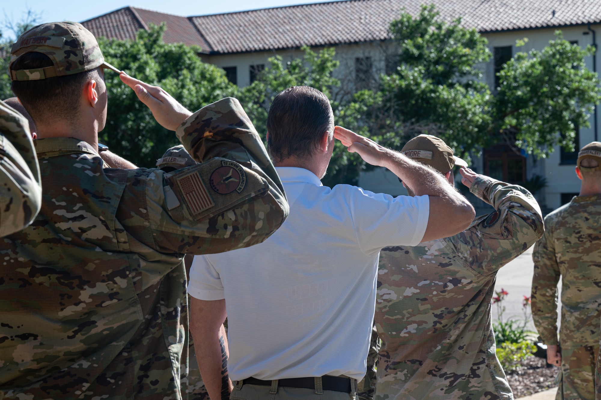 Montgomery Police Department Sgt. Robert Hubbard, middle, salutes the flag during an Air Force Leadership School retreat practice at Maxwell Air Force Base, Alabama, May 14, 2026.