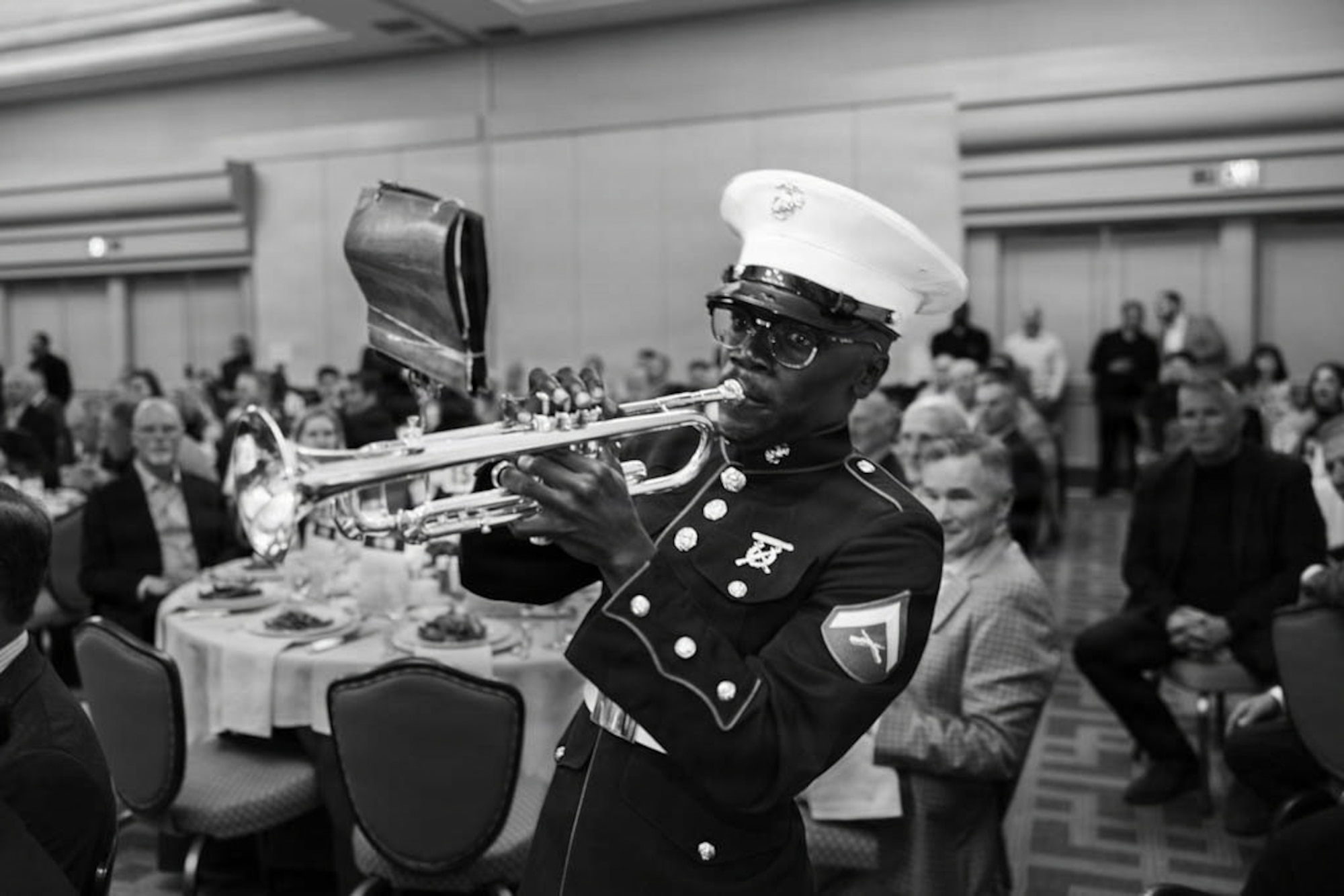 U.S. Marine Corps Lance Cpl. Rigel Robinson Jr., a musician with Marine Band San Diego, performs for guests during the Patriots at Pebble, Eagle, Globe and Anchor Dinner at Pebble Beach, California, March 1, 2026. The Patriots at Pebble event has been hosted by the Marine Corps Scholarship Foundation since 1962. The Foundation has provided over 31,000 scholarships, valuing over $235 million dollars. Marine Band San Diego performs a wide variety of music at military ceremonies and civilian events throughout the Western Recruiting Region. (U.S. Marine Corps photo illustration by Lance Cpl. Brooke Pedersen)