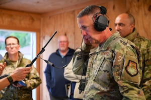 U.S. Air Force Brig. Gen. Jeffrey Phillips, Air Combat Command director of Cyberspace Operations and Warfighting Communications (ACC/A6), tests communication equipment during the Raptor Town Tactical Communications Demonstration at Joint Base Langley-Eustis, Virginia, May 7, 2026. The event provided an environment for leaders from across the Air Force to discuss innovative solution for deployable network kits.