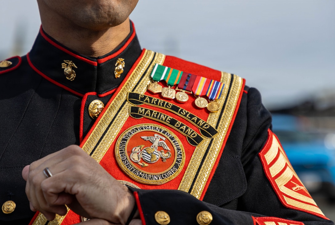 U.S. Marine Corps Gunnery Sgt. Christian Guin, Drum Major for the Marine Corps Recruit Depot Parris Island Marine Band, adjusts his uniform in preparation for the Saint Patrick's Day Parade on March 14, 2026. The Parris Island Marine Band performed musical numbers alongside local organizations and performers for Boston residents celebrating the holiday. (U.S. Marine Corps photo by Cpl. Kenneth Johnson)