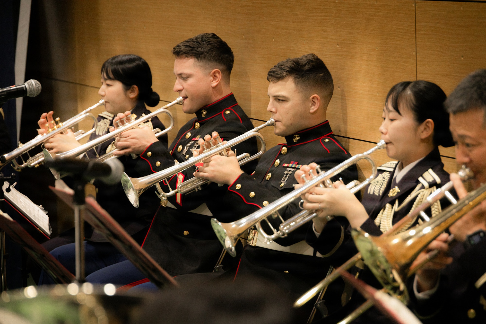 U.S. Marine Corps Sgt. Jeremy Holifield, second from left, and Cpl. Bryce Trollinger, both trumpet instrumentalists with the III Marine Expeditionary Force Band, perform alongside Japan Ground Self-Defense Force members with the 15th Brigade Band, at Camp Yonaguni, Yonaguni, Japan, March 27, 2026. The performance celebrated the 10th anniversary of Camp Yonaguni and served to strengthen the relationships between the forces. Holifield is a native of Tennessee and Trollinger is a native of Missouri. (U.S. Marine Corps photo by Cpl. Giovanni Navarrette)