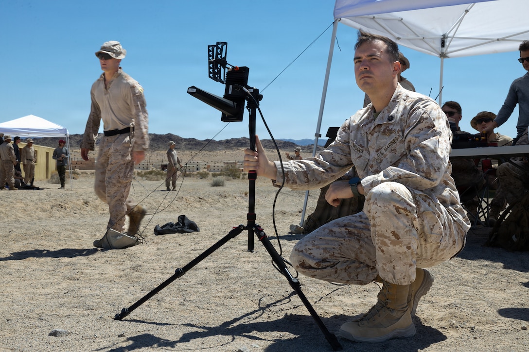 U.S. Marine Corps SSgt. Anthony D. Wilcox, a Maryland native, small unmanned aircraft system specialist with 2nd Battalion, 7th Marine Regiment, 1st Marine Division, observes a first-person attack drone at Range 100, Marine Corps Air Ground Combat Center, Twentynine Palms, California, May 20, 2026. Through intensive hands-on training, the course equips service members with tactical first-person view piloting skills, directly enhancing lethality and survivability in contested environments. (U.S. Marine Corps photo by Pfc. Ethan DePaul)