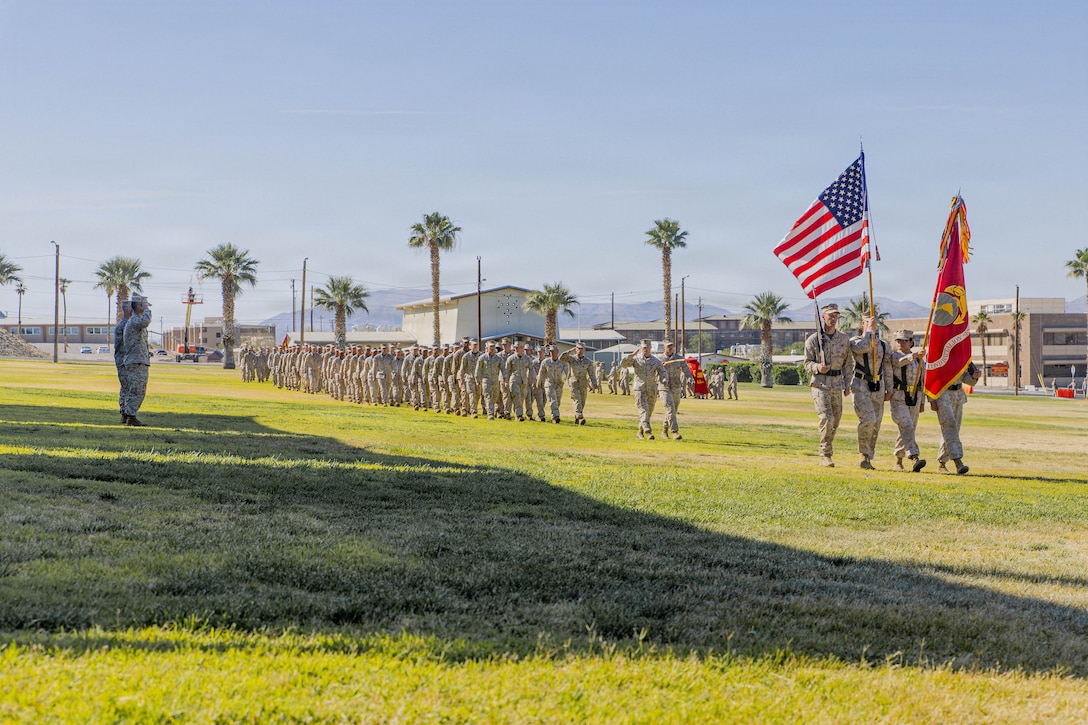 U.S. Marine Corps Lt. Col. Brandon Salter, outgoing commanding officer of 2nd Battalion, 7th Marines, 1st Marine Division, and Lt. Col. Colin Elsasser, incoming commanding officer of 2nd Battalion, 7th Marines, 1st Marine Division, salute during pass and review at Lance Cpl. Torrey Grey Field, Marine Corps Air Ground Combat Center, Twentynine Palms, California, May 21, 2026. This change of command ceremony represents the official passing of authority from the outgoing commanding officer, Lt. Col. Brandon Salter, to the incoming commanding officer, Lt. Col. Colin Elsasser. (U.S. Marine Corps photo by Lance Cpl. Gracelyn Hanson)
