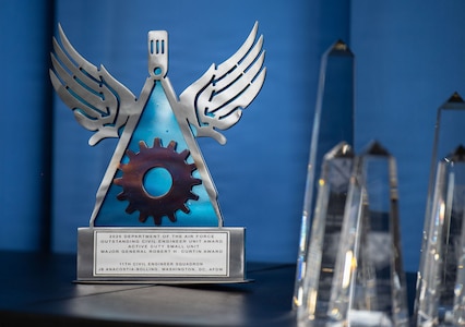 An award sits on a table during the Civil Engineer Annual Functional Awards ceremony at Joint Base Anacostia-Bolling, Washington, D.C., May 27, 2026. The Robert H. Curtin Award was presented to the 11th Civil Engineer Squadron for outstanding service in the small unit category. (U.S. Air Force photo by Airman 1st Class Brandon Thomas)