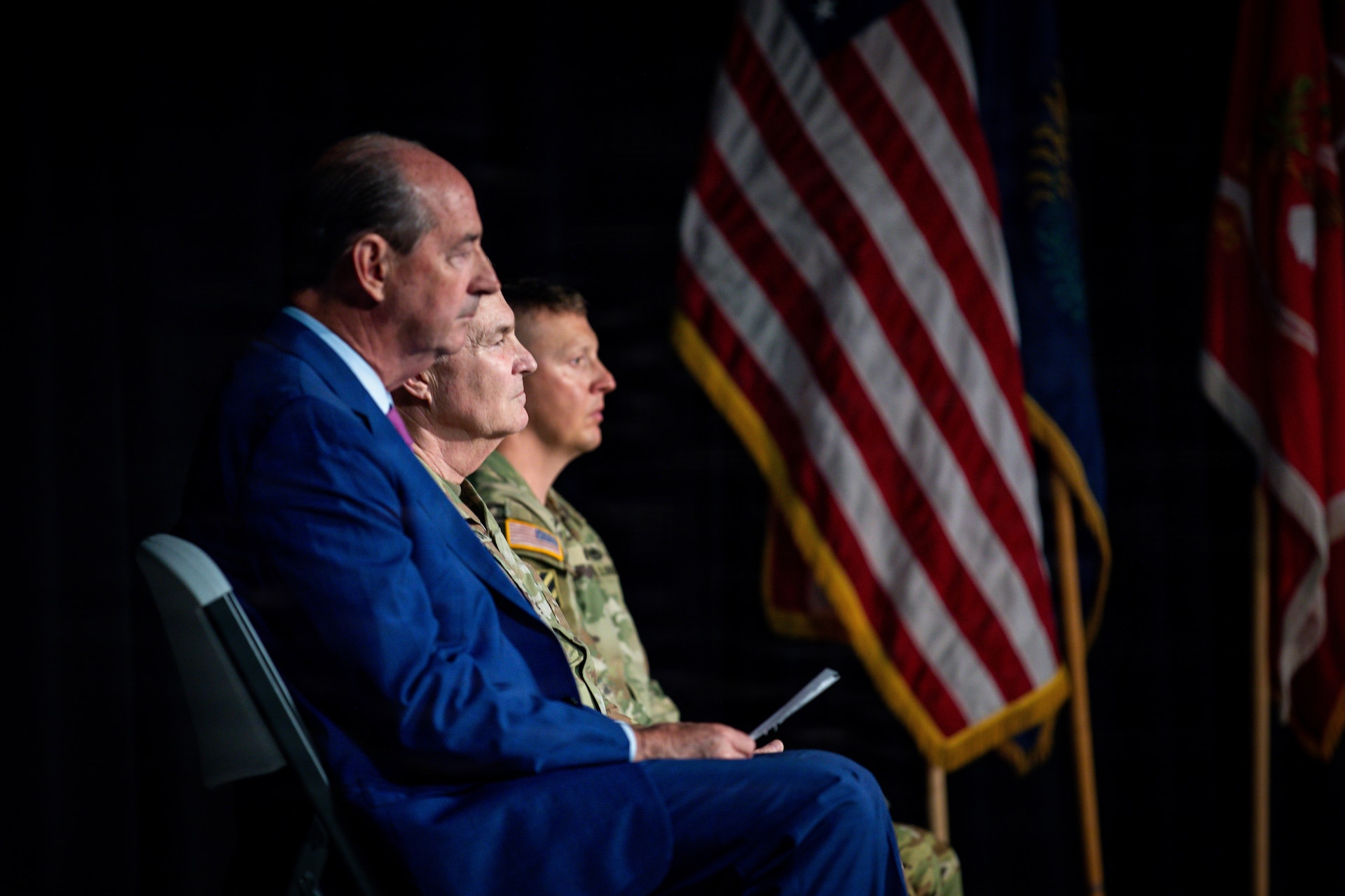 Rocky Adkins, senior advisor to Kentucky Governor Andy Beshear; U.S. Army Maj. Gen. Haldane B. Lamberton, Kentucky's adjutant general; and U.S. Army Command Sgt. Maj. Randy Morris, deployment command sergeant major, listen during the 201st Engineer Battalion's departure ceremony that took place at the Boyd County Community Center in Catlettsburg, Kentucky, May 30, 2026.