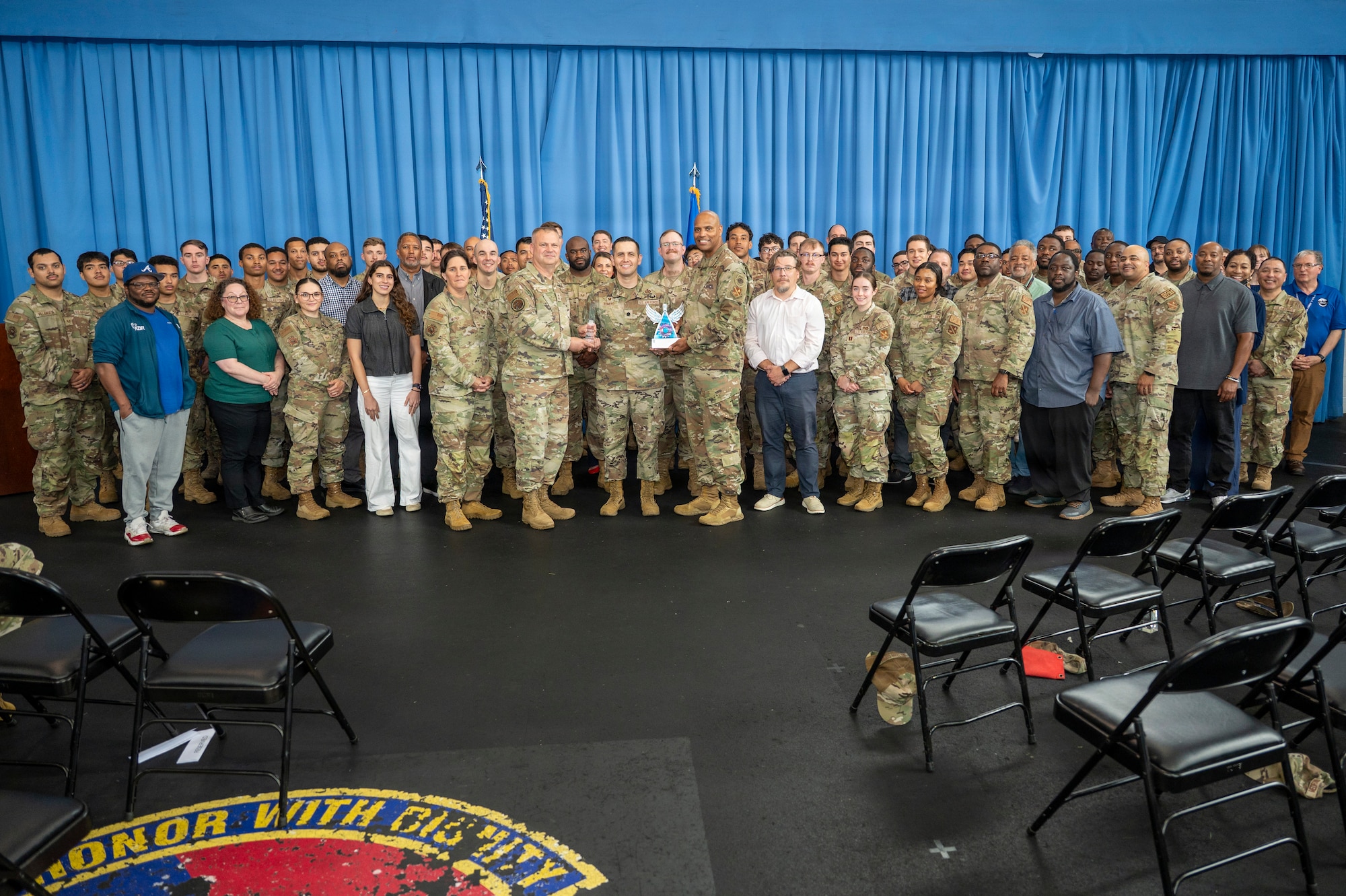 U.S. Air Force Maj. Gen. Daniel DeVoe (center left) and Command Chief Master Sgt. Michael Wynne (center right), command team for the Air Force District of Washington and the 320th Air Expeditionary Wing, pose with the 11th Civil Engineer Squadron at Joint Base Anacostia-Bolling, Washington D.C., May 27, 2026. The awards celebrated and recognized the excellence, hard work, and leadership of the 11th CES. (U.S. Air Force photo by Senior Airman Shanel Toussaint)