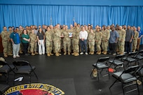 U.S. Air Force Maj. Gen. Daniel DeVoe (center left) and Command Chief Master Sgt. Michael Wynne (center right), command team for the Air Force District of Washington and the 320th Air Expeditionary Wing, pose with the 11th Civil Engineer Squadron at Joint Base Anacostia-Bolling, Washington D.C., May 27, 2026. The awards celebrated and recognized the excellence, hard work, and leadership of the 11th CES. (U.S. Air Force photo by Senior Airman Shanel Toussaint)