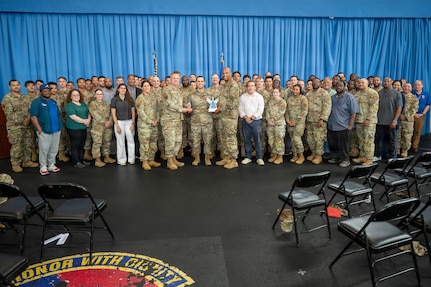 U.S. Air Force Maj. Gen. Daniel DeVoe (center left) and Command Chief Master Sgt. Michael Wynne (center right), command team for the Air Force District of Washington and the 320th Air Expeditionary Wing, pose with the 11th Civil Engineer Squadron at Joint Base Anacostia-Bolling, Washington D.C., May 27, 2026. The awards celebrated and recognized the excellence, hard work, and leadership of the 11th CES. (U.S. Air Force photo by Senior Airman Shanel Toussaint)