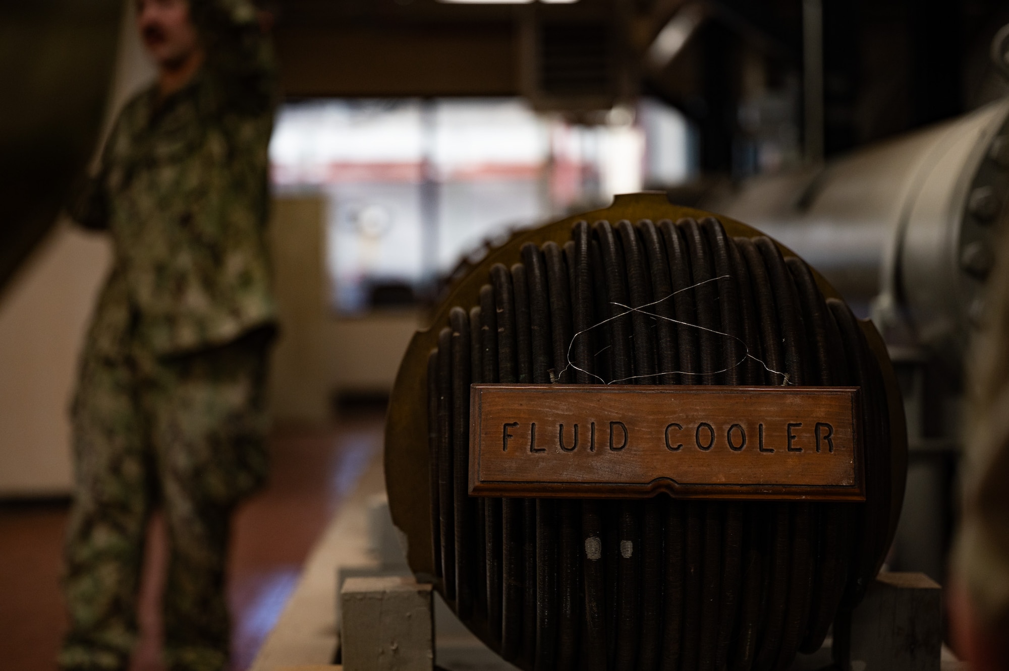 The arresting gear fluid cooler displays in a hangar at Joint Base McGuire-Dix-Lakehurst, N.J., May 20, 2026. U.S. service members attending the Leading Edge course learned that the arresting gear fluid cooler consists of many U-shaped tubes that allows sea water to flow through and cool the arresting gear fluid during operation. (U.S. Air Force photo by Airman 1st Class Haeleigh Bayle)