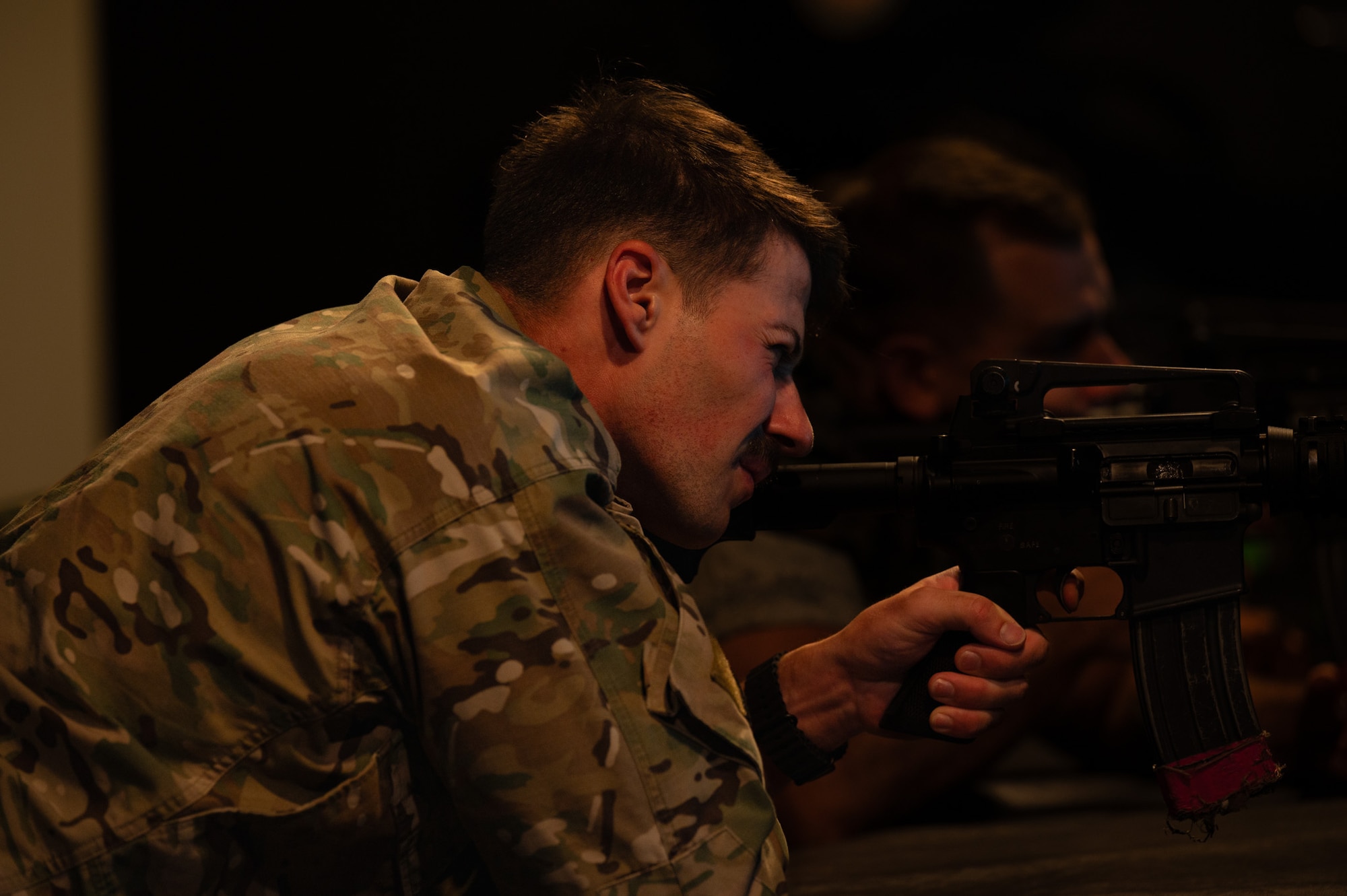 U.S. Air Force Staff Sgt. Matt D’Ambrosia, 421st Combat Training Squadron Phoenix Raven Qualification Course and Flyaway Security Course instructor, fires an M4 carbine simulator during electronic simulation training as part of the Leading Edge course at Joint Base McGuire-Dix-Lakehurst, N.J., May 21, 2026. The simulation training gave service members a chance to get comfortable handling an M4 weapon. (U.S. Air Force photo by Airman 1st Class Haeleigh Bayle)