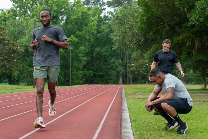 U.S. Airmen run on the base fitness track.
