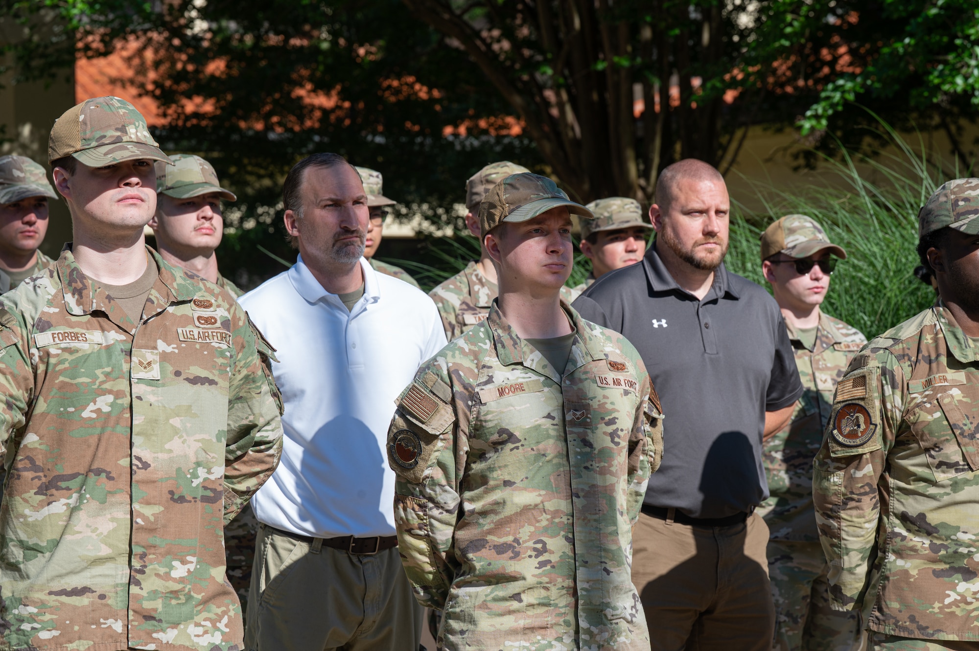 Montgomery Police Department Sgts. Adam Wright, back middle, and Robert Hubbard, back left, stand at parade rest during an Air Force Leadership School retreat practice at Maxwell Air Force Base, Alabama, May 14, 2026.
