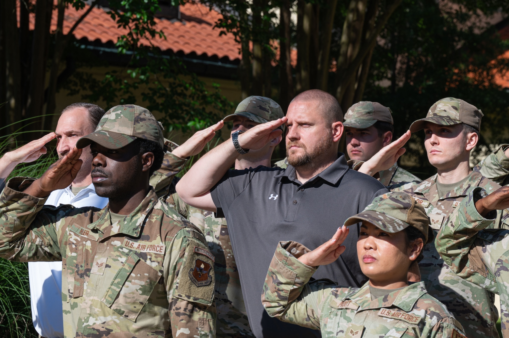 Montgomery Police Department Sgts. Robert Hubbard, back left, and Adam Wright back middle, salute the flag during an Air Force Leadership School retreat practice at Maxwell Air Force Base, Alabama, May 14, 2026.