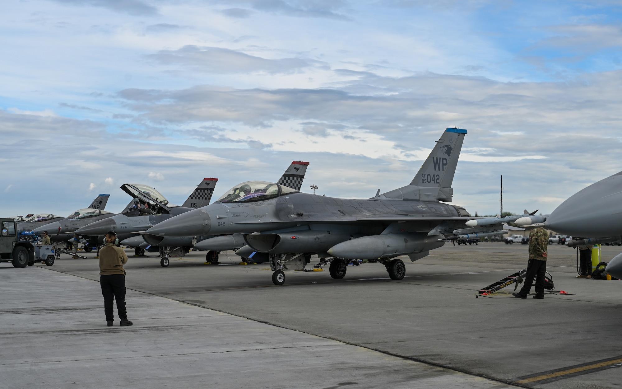 Aircrew standby to signal U.S. Air Force F-16 Fighting Falcon pilots on the flightline during RED FLAG Alaska 26-2 at Eielson Air Force Base, Alaska, June 1, 2026.