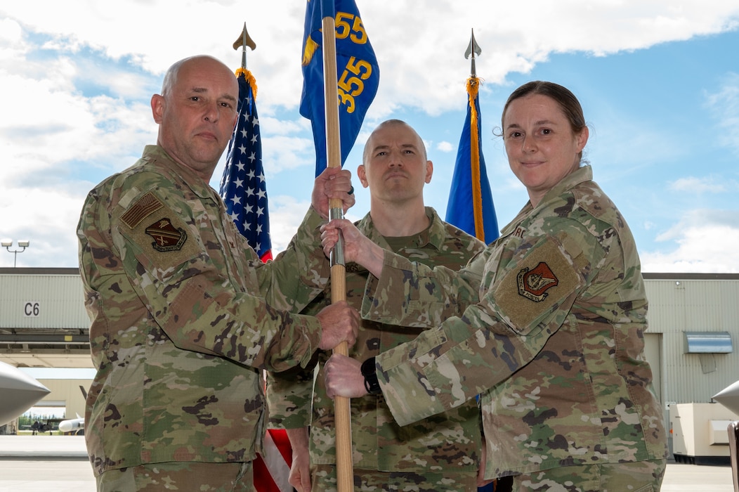 U.S. Air Force Col. Joseph Gilpin, left, 354th Maintenance Group commander, and Maj. Allana Gallant, outgoing 355th Fighter Generation Squadron commander, holds a guidon during the 354th Aircraft Maintenance Squadron activation ceremony on Eielson Air Force Base, Alaska, June 1, 2026.