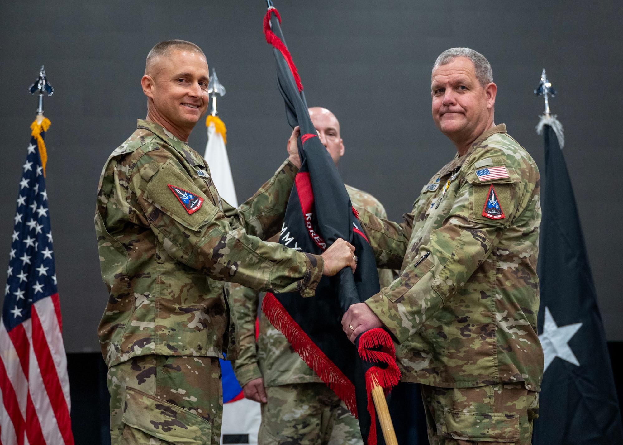 U.S. Space Force Col. John Patrick, right, outgoing U.S. Space Forces - Korea commander, relinquishes command of USSF-K to U.S. Space Force Brig. Gen. Brian Denaro, left, U.S. Space Forces Indo-Pacific commander, during a change of command ceremony at Osan Air Base, Republic of Korea, June 2, 2026. Patrick established a 24/7 operation center, launched the first overseas Joint Commercial Operations site and deepened cooperation with ROK military and government partners to strengthen space domain awareness and operational integration. (U.S. Air Force photo by Staff Sgt. Sarah Williams)
