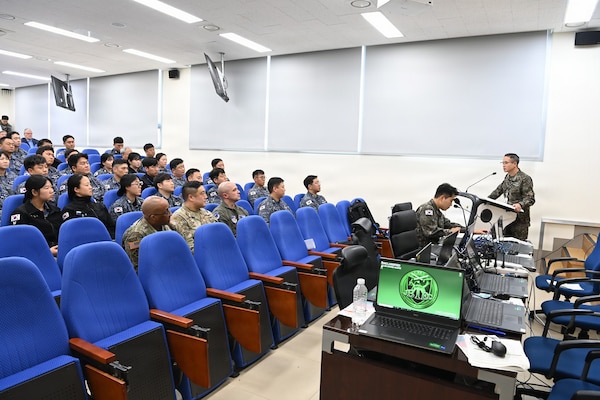 ROK and US military members sitting in an auditorium