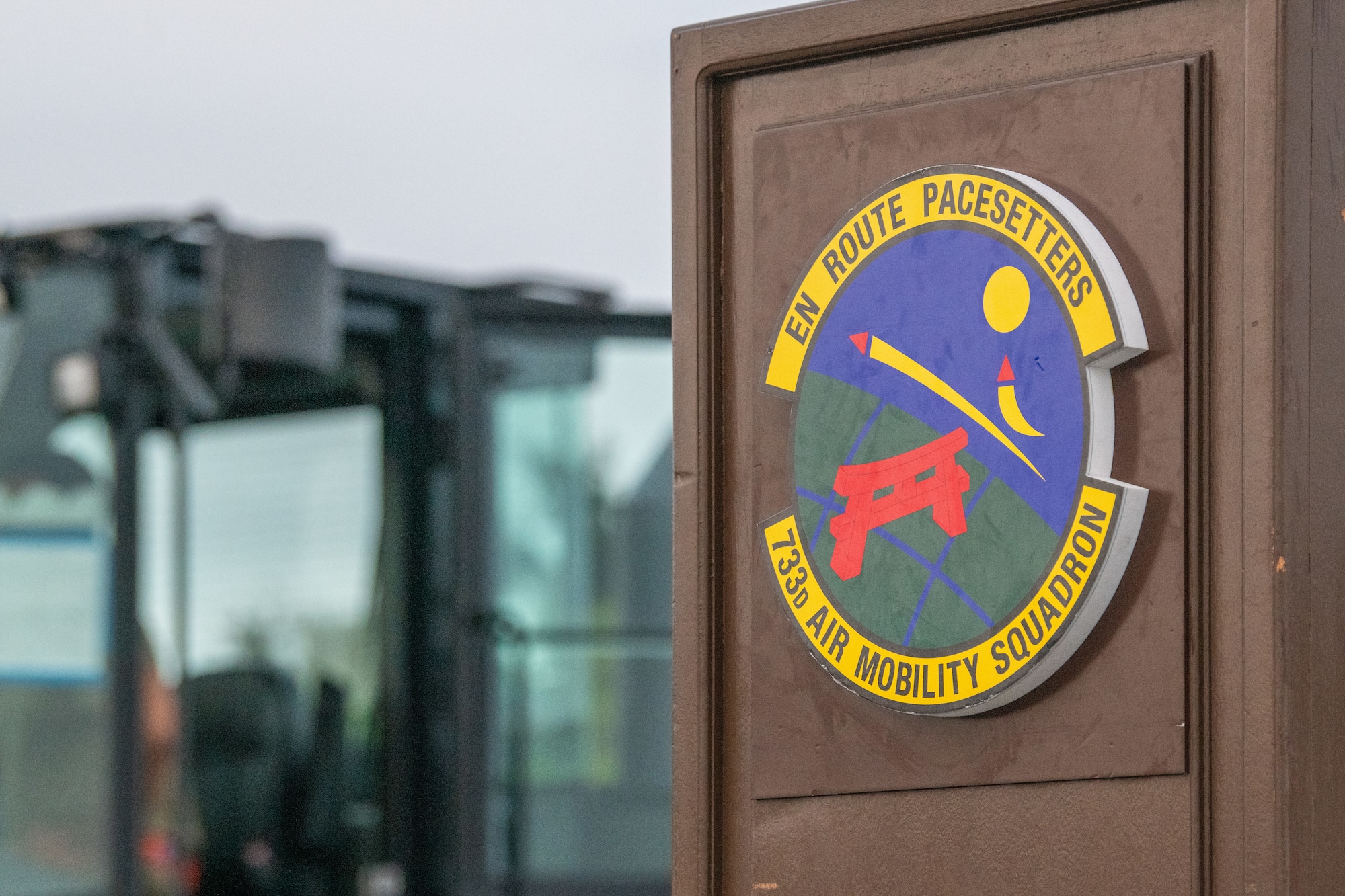 A sign displays the 733rd Air Mobility Squadron logo