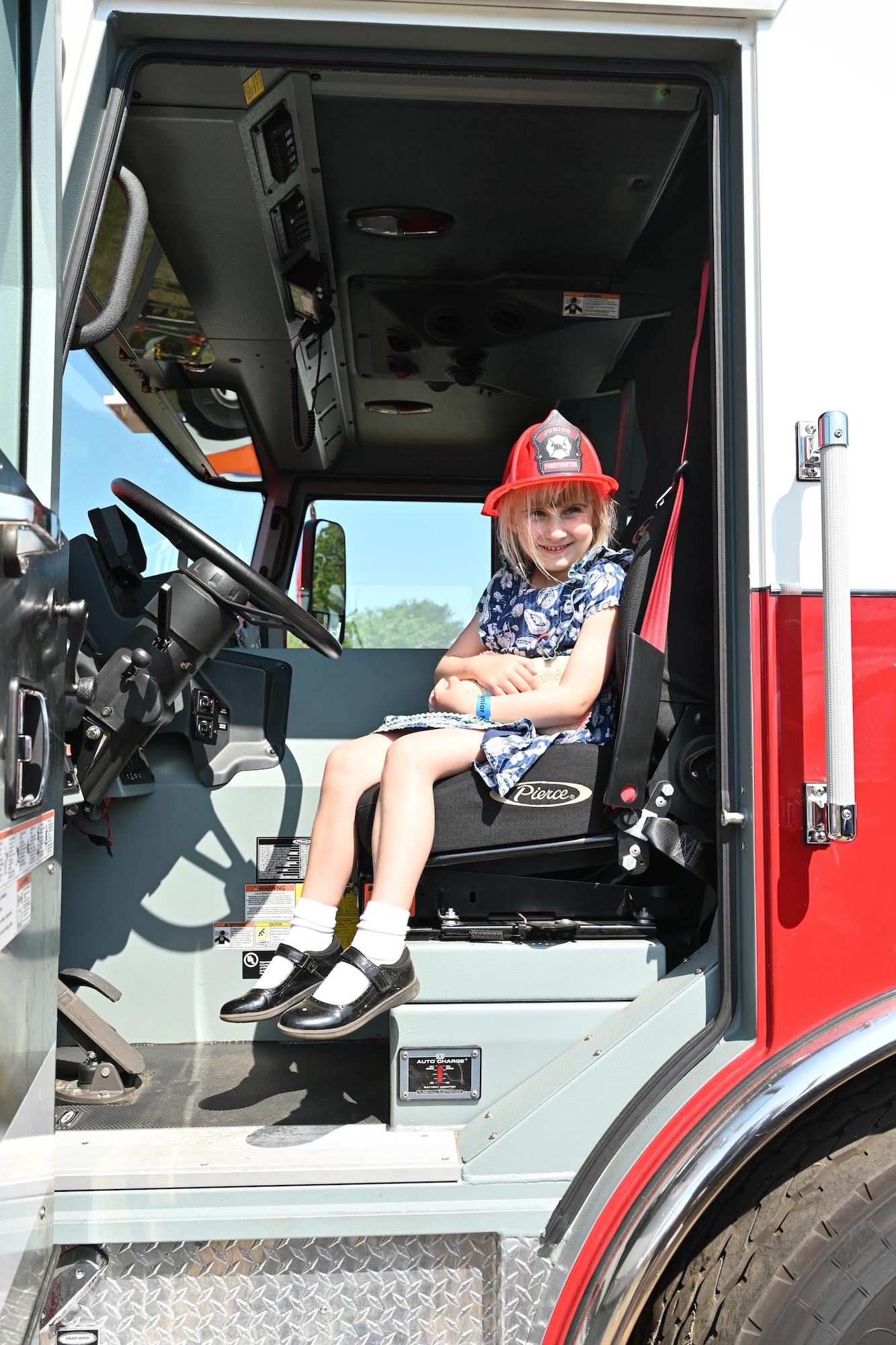 Alexandra Palmer checks out a U.S. Air Force fire truck at the Suffolk Show in Ipswich, England, May 27, 2026.  Airmen from RAF Mildenhall and RAF Lakenheath spent two days at the Suffolk Show showcasing their equipment and capabilities and were joined by British military and cadet forces in the “Military Zone” area of the event. (U.S. Air Force photo by Karen Abeyasekere)
