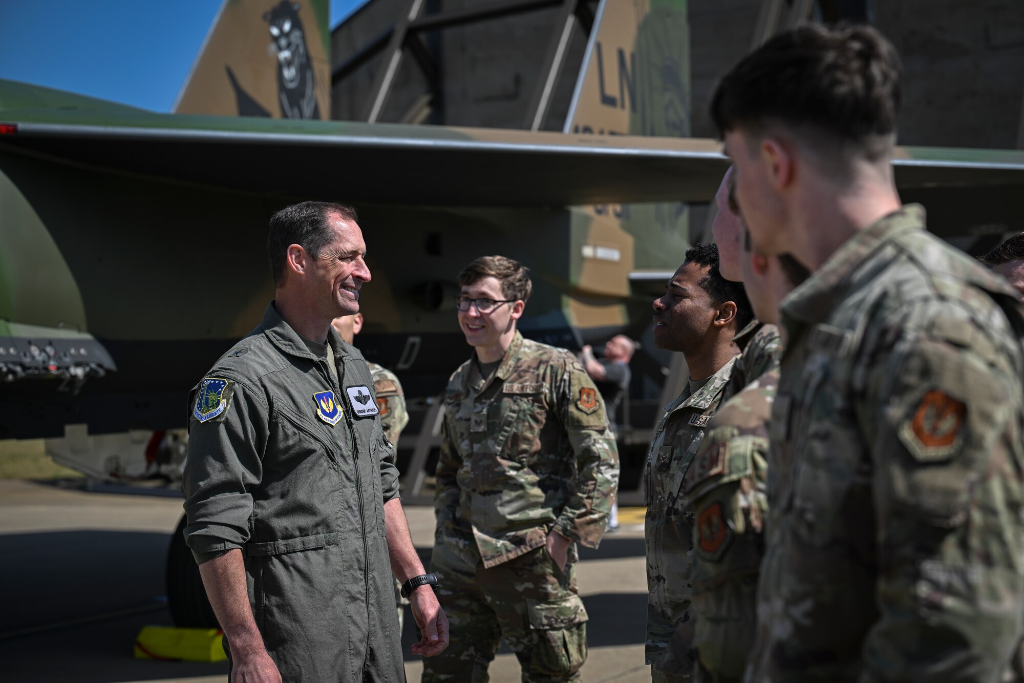 The commander chats with Airmen in front of the newly painted Operation El Dorado tailflash.