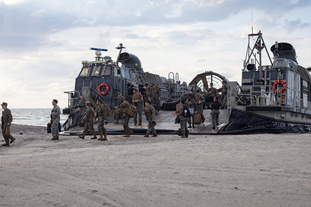 U.S. Marines and Sailors with the 22nd Marine Expeditionary Unit (Special Operations Capable) offload from a U.S. Navy landing craft, air cushion assigned to Assault Craft Unit 4, Naval Beach Group 2, during beach operations at Marine Corps Base Camp Lejeune, North Carolina, June 1, 2026. U.S. Marines and Sailors with the 22nd MEU (SOC) return home from a nearly 10-month deployment to support U.S. Southern Command to counter illicit threats, strengthen regional partnerships and protect the homeland. (U.S. Marine Corps photo by Sgt. Rafael Brambila-Pelayo)