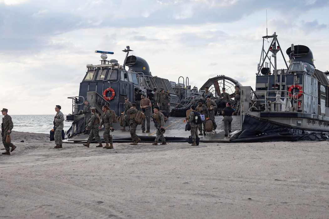 U.S. Marines and Sailors with the 22nd Marine Expeditionary Unit (Special Operations Capable) offload from a U.S. Navy landing craft, air cushion assigned to Assault Craft Unit 4, Naval Beach Group 2, during beach operations at Marine Corps Base Camp Lejeune, North Carolina, June 1, 2026. U.S. Marines and Sailors with the 22nd MEU (SOC) return home from a nearly 10-month deployment to support U.S. Southern Command to counter illicit threats, strengthen regional partnerships and protect the homeland. (U.S. Marine Corps photo by Sgt. Rafael Brambila-Pelayo)