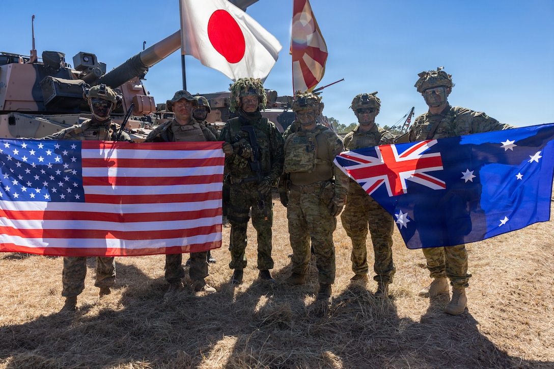 U.S. Marines with 1st Battalion, 5th Marine Regiment, Marine Rotational Force – Darwin 26, members of the Japanese Ground Self Defense Force, and Australian Army Soldiers with 1st Division pose for a photo after the opening ceremony of Exercise Southern Jackaroo in Townsville Field Training Area, Australia, May 29, 2026. Exercise Southern Jackaroo is a trilateral training event between the armed forces of Australia, Japan, and the United States that builds combined combat readiness and interoperability in the Indo-Pacific through joint operations and live-fire training. (U.S. Marine Corps photo by Sgt. Kyle Chan)
