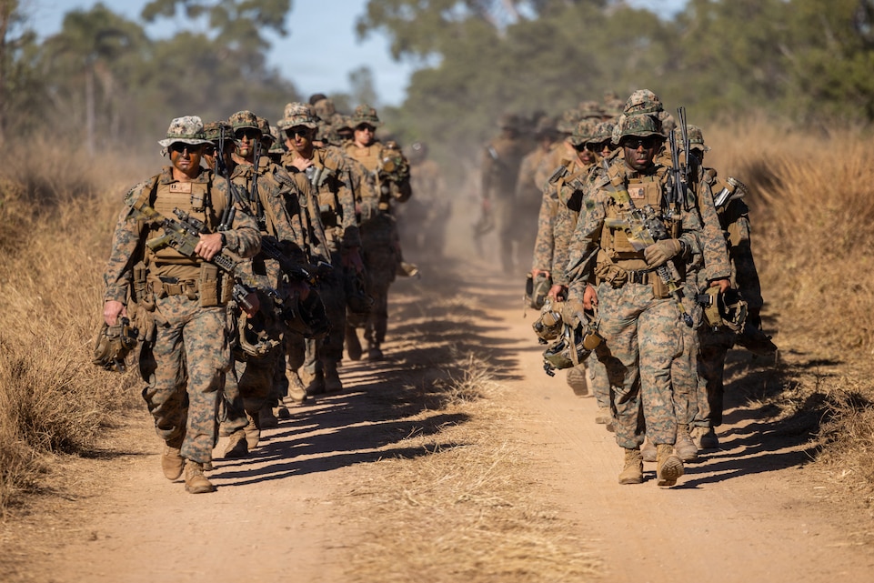 U.S. Marines with Alpha Company, 1st Battalion, 5th Marine Regiment, Marine Rotational Force – Darwin 26, walk to the opening ceremony of Exercise Southern Jackaroo in Townsville Field Training Area, Australia, May 29, 2026. Exercise Southern Jackaroo is a trilateral training event between the armed forces of Australia, Japan, and the United States that builds combined combat readiness and interoperability in the Indo-Pacific through joint operations and live-fire training. (U.S. Marine Corps photo by Sgt. Kyle Chan)
