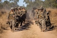 U.S. Marines with Alpha Company, 1st Battalion, 5th Marine Regiment, Marine Rotational Force – Darwin 26, walk to the opening ceremony of Exercise Southern Jackaroo in Townsville Field Training Area, Australia, May 29, 2026. Exercise Southern Jackaroo is a trilateral training event between the armed forces of Australia, Japan, and the United States that builds combined combat readiness and interoperability in the Indo-Pacific through joint operations and live-fire training. (U.S. Marine Corps photo by Sgt. Kyle Chan)