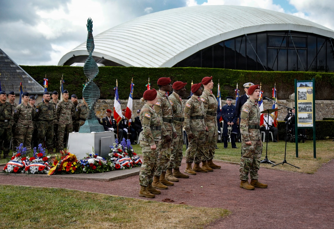 The 82nd Airborne Division “All-American” Chorus sings during a memorial ceremony at the Three Cemeteries Monument, Sainte-Mère-Église, France, June 2, 2026. The Three Cemeteries Monument honors the 14,000 U.S. troops, particularly from the 82nd Airborne Division, who fell during the battle to liberate Normandy, France. (U.S. Army photo by Staff Sgt. Catessa Palone)