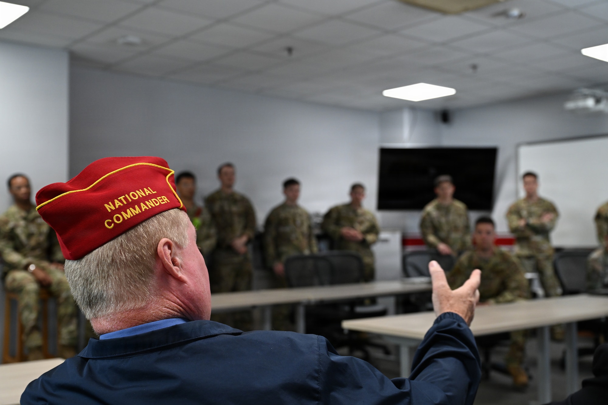 Commander Wiley converses with airmen in open questionnaire.