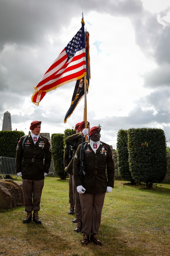 The 82nd Airborne Division Color Guard prepares to march at the conclusion of the Three Cemeteries Monument ceremony at Sainte-Mère-Église, France, June 2, 2026. The Three Cemeteries Monument honors the 14,000 U.S. troops, particularly from the 82nd Airborne Division, who fell during the battle to liberate Normandy, France. (U.S. Army photo by Staff Sgt. Catessa Palone)