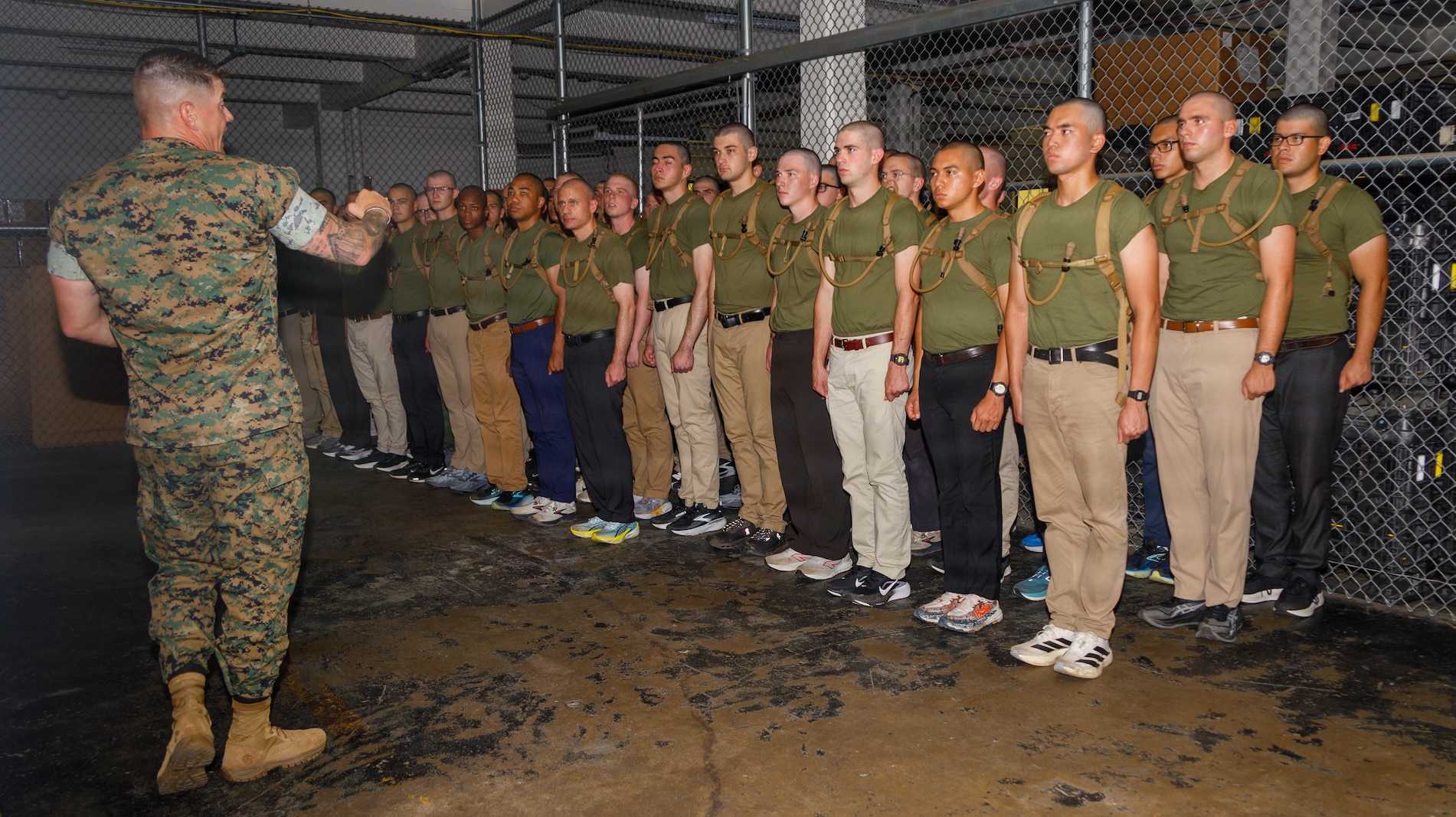 U.S. Marine Corps Gunnery Sgt. Shane Carter, left, a drill master with Officer Candidate School, gives instructions during the initial officer candidate uniform issue on Marine Corps Base Quantico, Virginia, May 27, 2026. The mission of OCS is to educate and train officer candidates in Marine Corps knowledge and skills within a controlled and challenging environment in order to evaluate and screen individuals for the leadership, moral, mental, and physical qualities required for commissioning as a Marine Corps officer. (U.S. Marine Corps photo by Lance Cpl. Lynsee Avila-Ramirez)