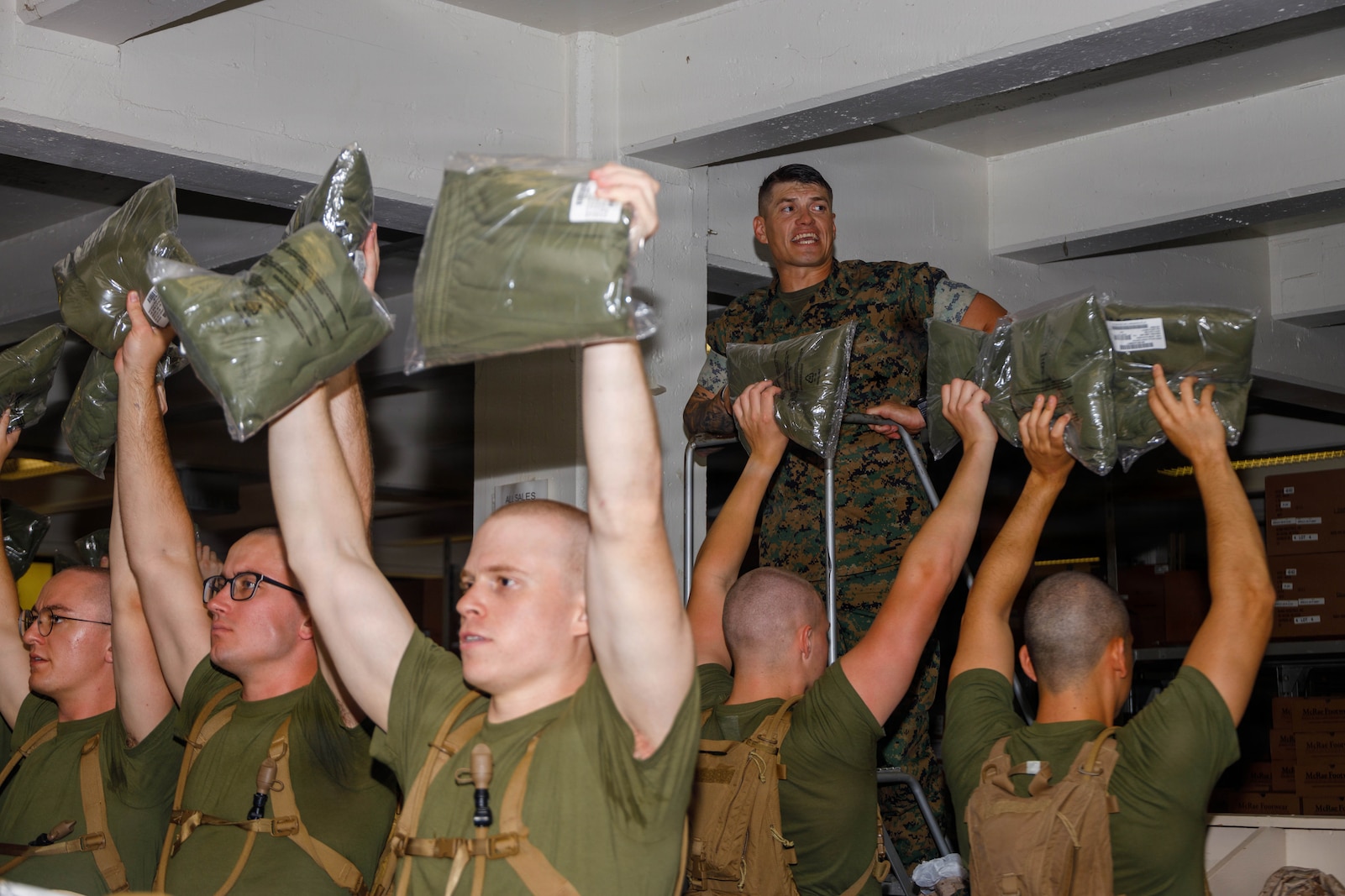 U.S. Marine Corps Gunnery Sgt. Shane Carter, a drill master with Officer Candidate School, gives instructions during the initial officer candidate uniform issue on Marine Corps Base Quantico, Virginia, May 27, 2026. The mission of OCS is to educate and train officer candidates in Marine Corps knowledge and skills within a controlled and challenging environment in order to evaluate and screen individuals for the leadership, moral, mental, and physical qualities required for commissioning as a Marine Corps officer. (U.S. Marine Corps photo by Lance Cpl. Lynsee Avila-Ramirez)