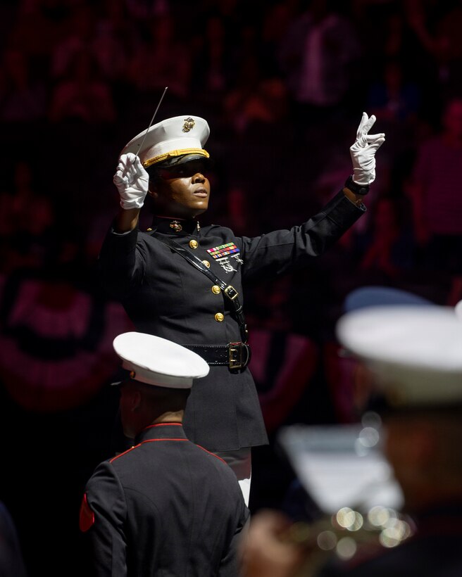 U.S. Marine Corps Chief Warrant Officer 2 Mardia Tompo, the conductor of 3rd Marine Aircraft Wing Band, conducts for the opening of the Virginia International Tattoo in Norfolk, Virginia, April 17, 2026. The Virginia International Tattoo is an annual event consisting of performances from military bands, drill teams, dancers and singers from around the world. The event celebrated the alliances between the U.S., the U.K., Canada, France, and South Korea. (U.S. Marine Corps photo by Lance Cpl. Zoey Williams)