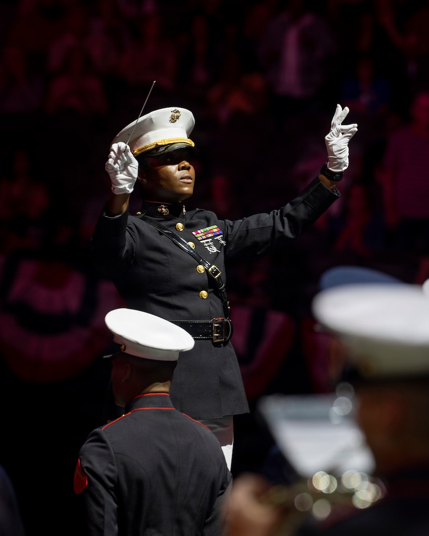 U.S. Marine Corps Chief Warrant Officer 2 Mardia Tompo, the conductor of 3rd Marine Aircraft Wing Band, conducts for the opening of the Virginia International Tattoo in Norfolk, Virginia, April 17, 2026. The Virginia International Tattoo is an annual event consisting of performances from military bands, drill teams, dancers and singers from around the world. The event celebrated the alliances between the U.S., the U.K., Canada, France, and South Korea. (U.S. Marine Corps photo by Lance Cpl. Zoey Williams)