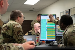 Airmen from the 732nd Air Mobility Squadron review simulated flight plans during Exercise ARCTIC BRIDGE, May 12, 2026, on Joint Base Elmendorf-Richardson, Alaska.